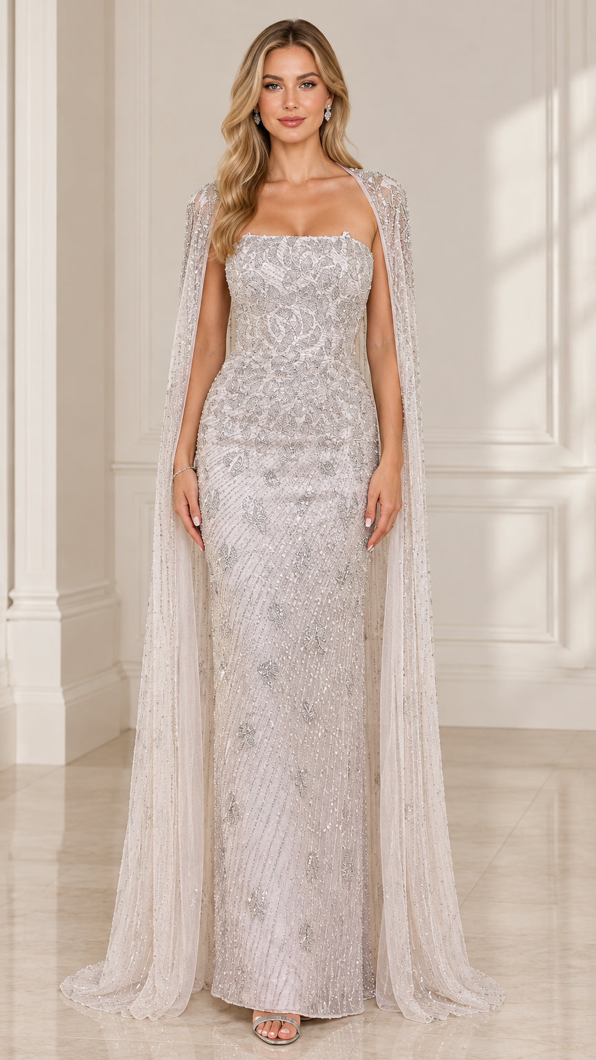 Front view of woman wearing silver strapless beaded evening gown with matching floor-length cape