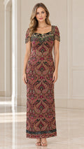 Front view of model wearing burgundy paisley beaded maxi evening gown with fringe sleeves