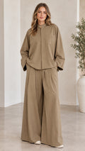 Front full-length view of woman wearing khaki two-piece shirt and wide-leg pants set
