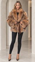 Front full view of woman wearing Camel plush faux fur belted coat with black leggings and heels