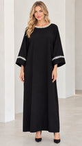 Front view of woman wearing black pearl-embellished modest maxi dress