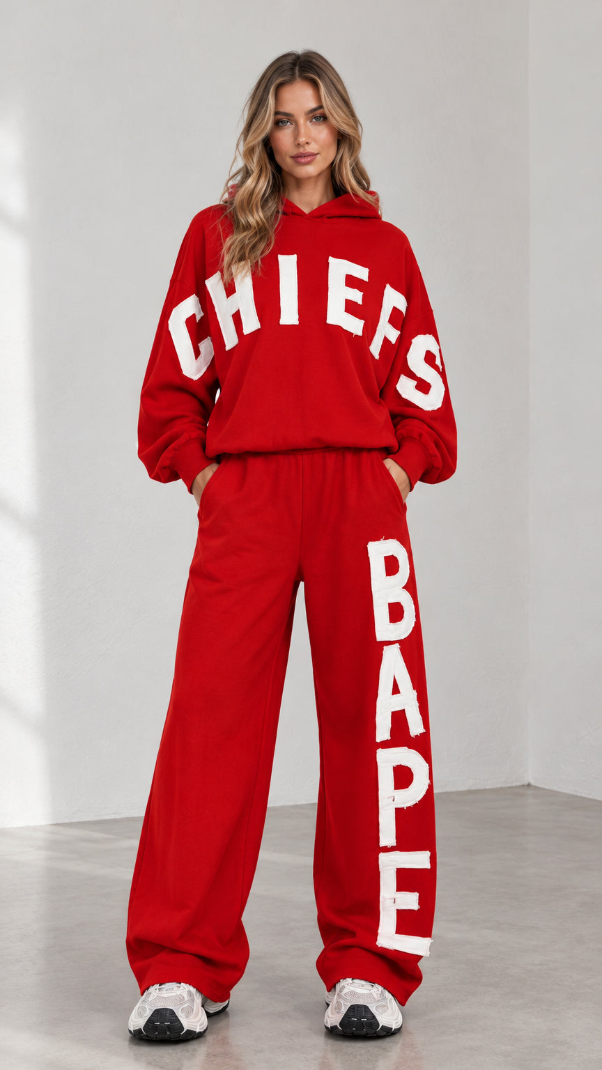 Front full view of woman wearing red letter print oversized hoodie and wide-leg sweatpants set