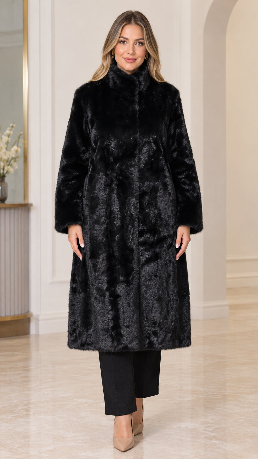 Front view of woman wearing black stand collar longline faux fur coat with black trousers and heels