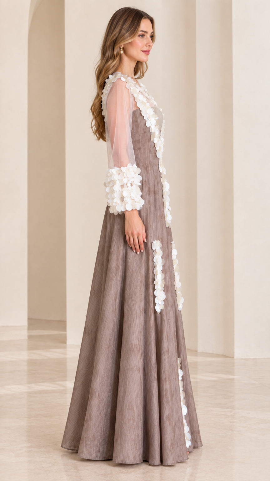 Side profile view of taupe maxi evening dress showing long sheer sleeves and flowing A-line skirt