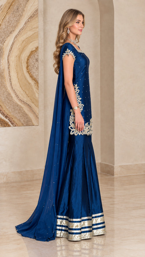 Side profile of royal blue cape sharara suit showing dramatic length