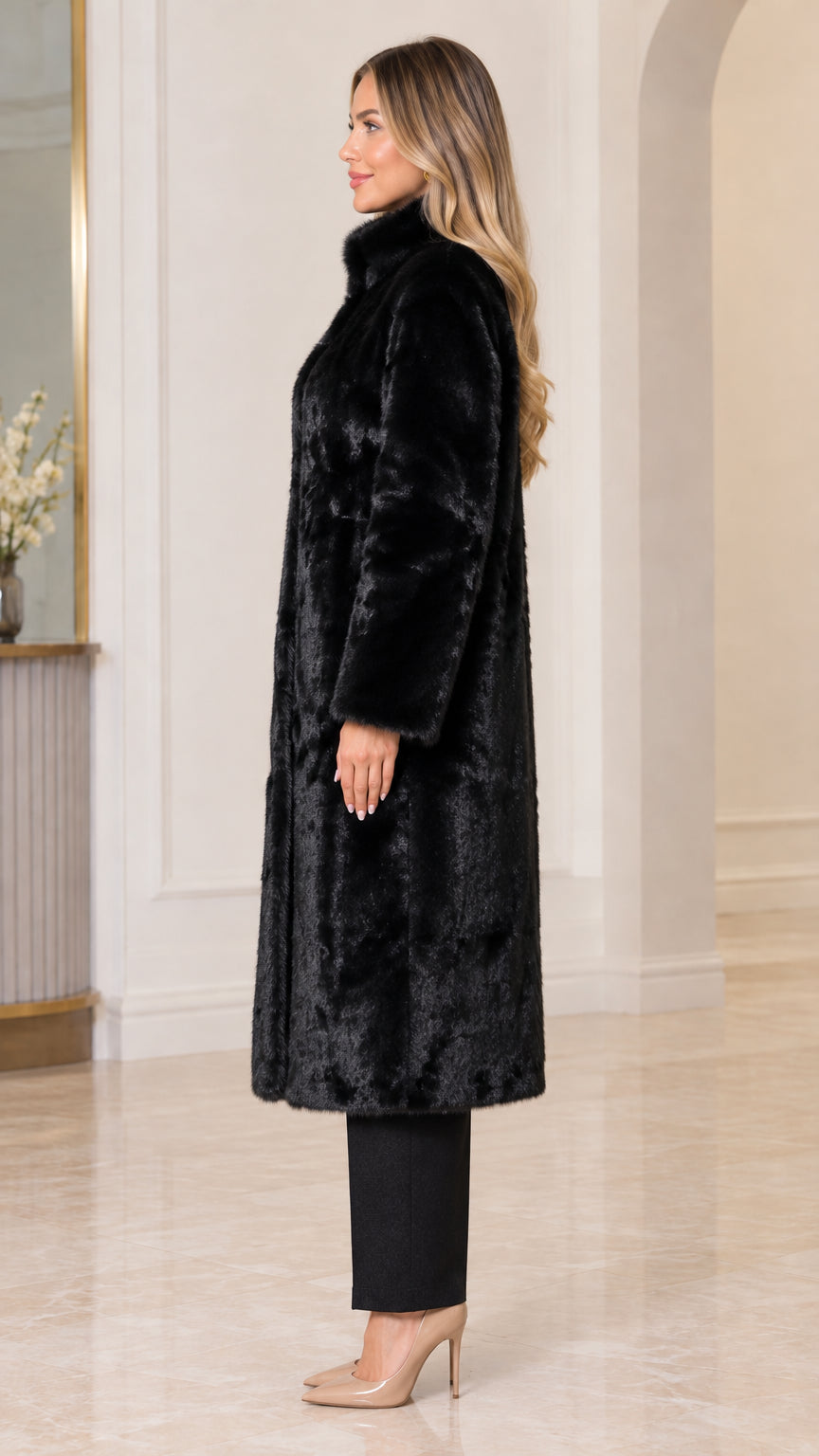 Side profile view of black longline faux fur overcoat showing structured stand collar