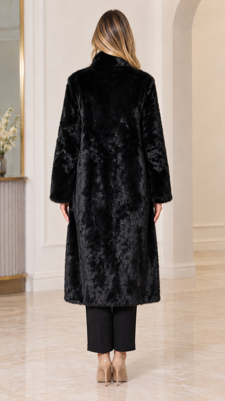 Back view of woman wearing elegant black midi faux fur winter coat