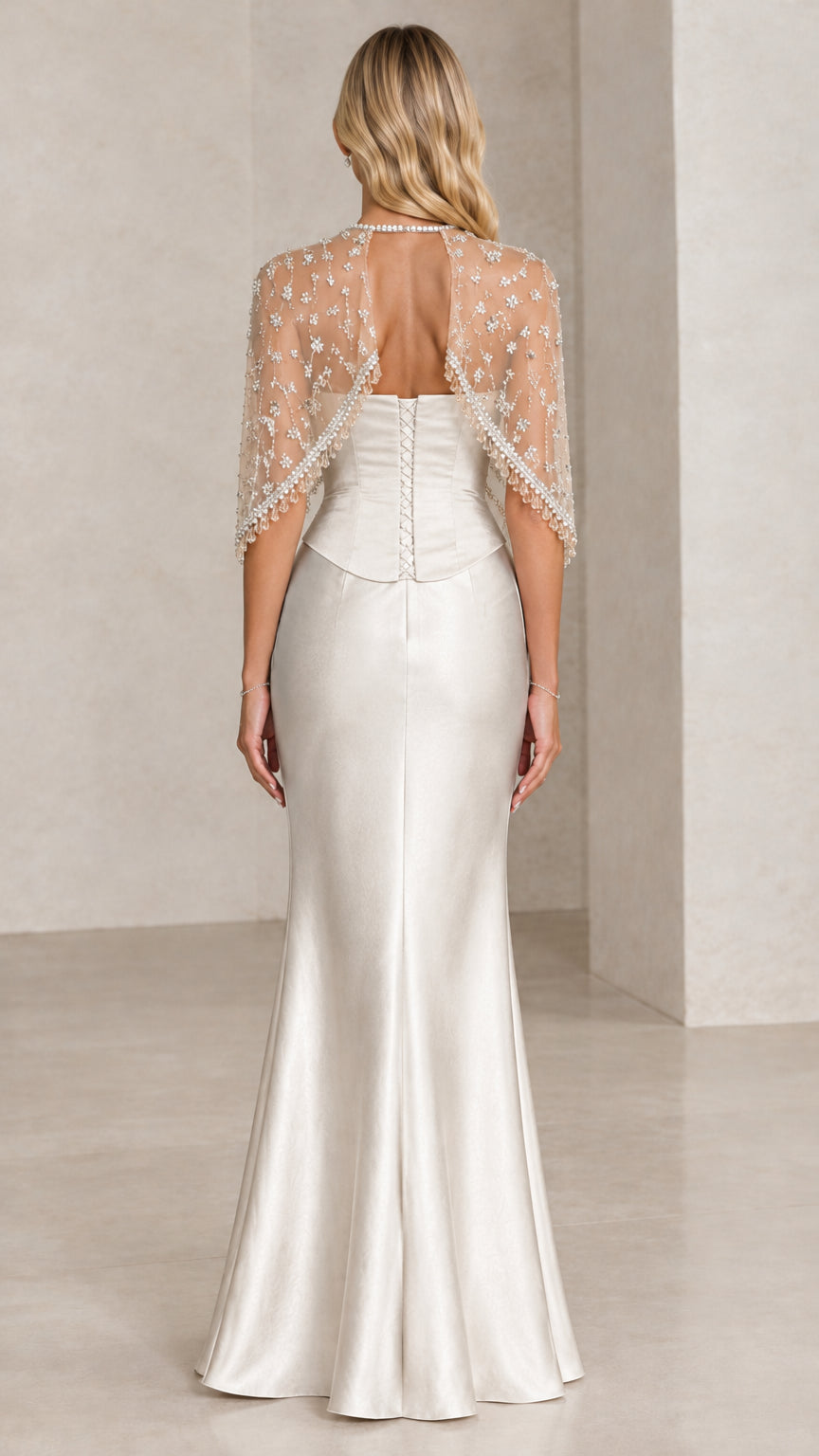 Back view of Champagne formal gown showing capelet and corset-style back detailing