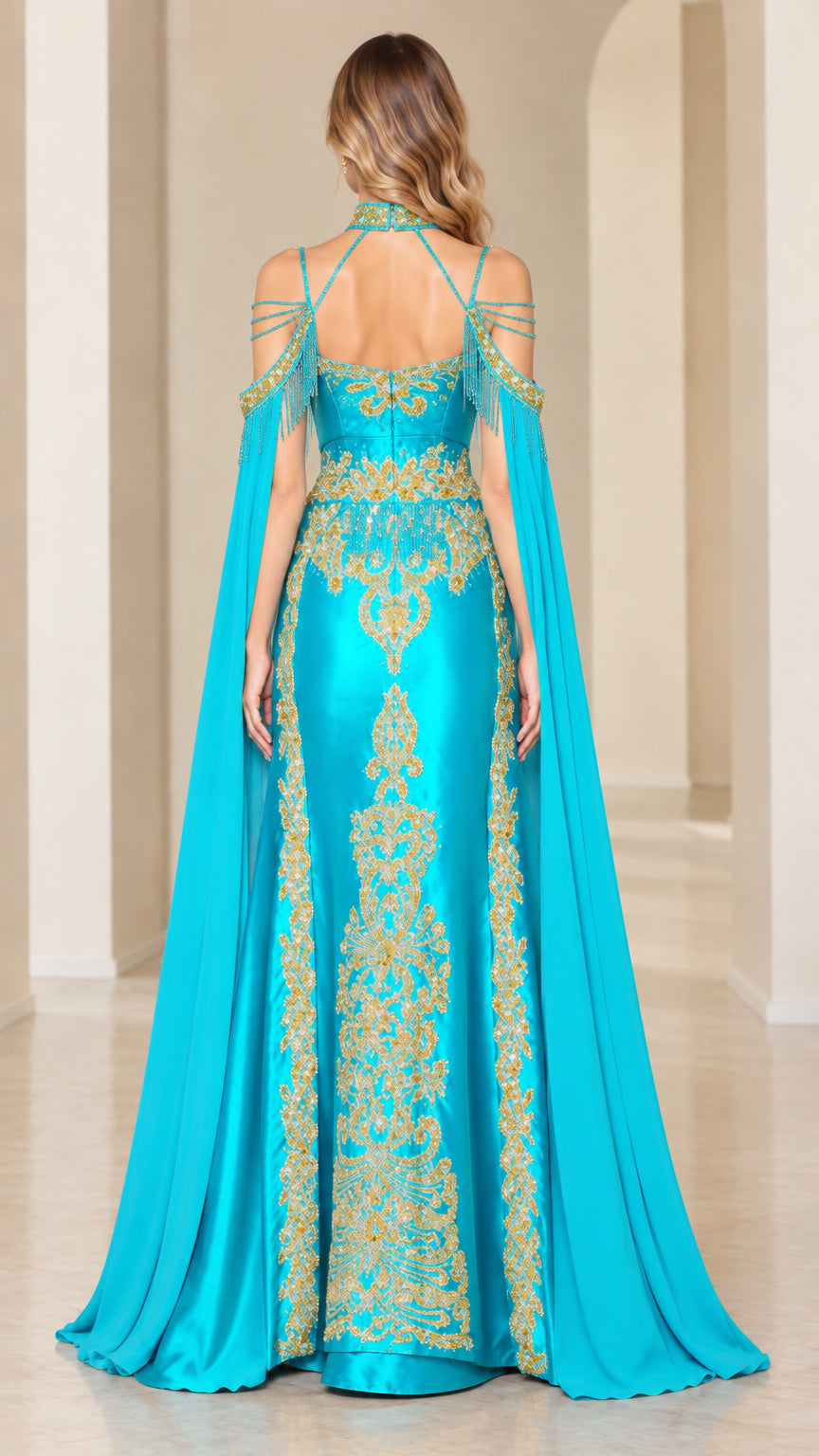Back view of turquoise cape gown showcasing sweeping back drape and gold embroidery