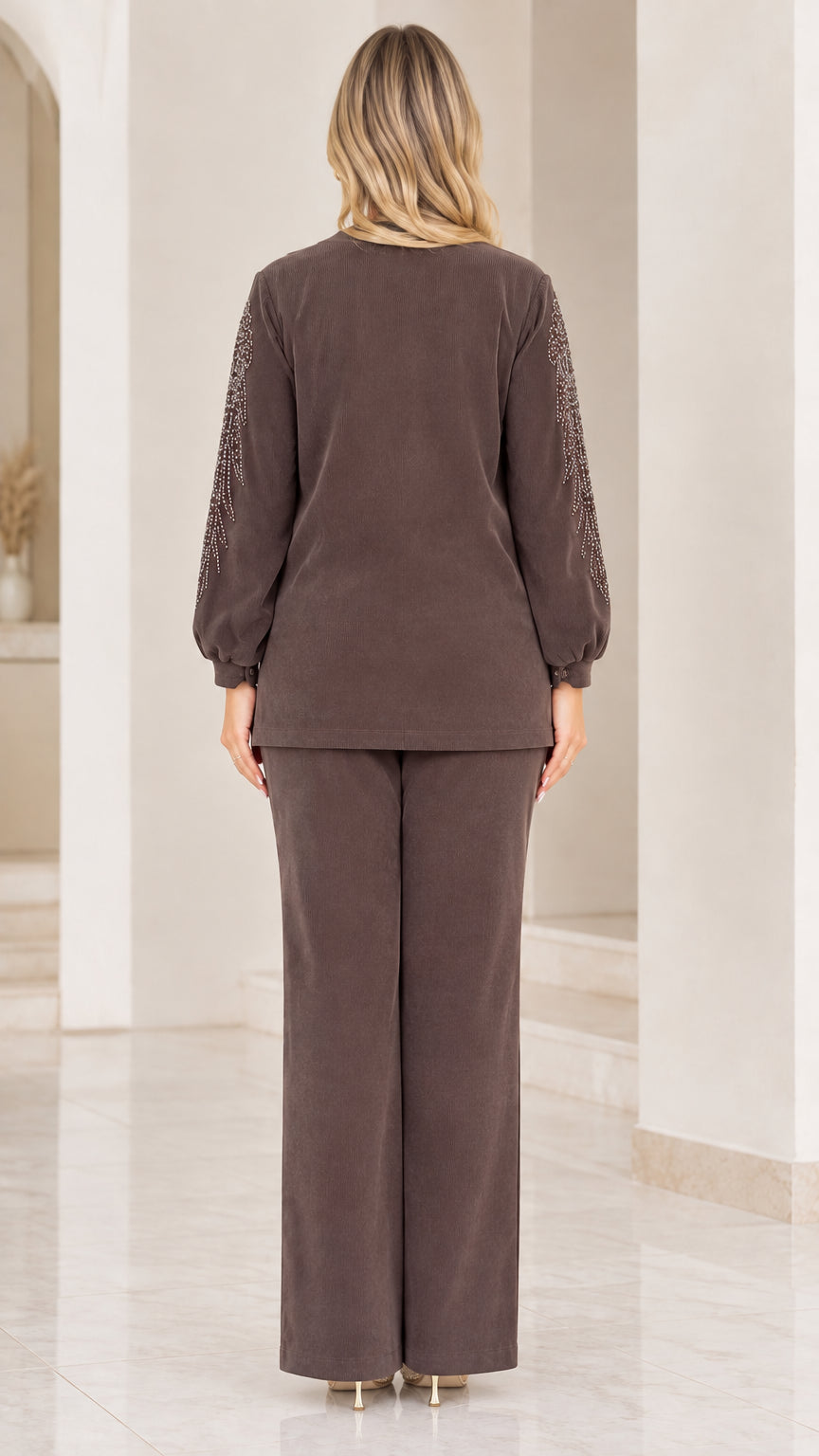 Back view of woman wearing brown ribbed long-sleeve top and trousers set