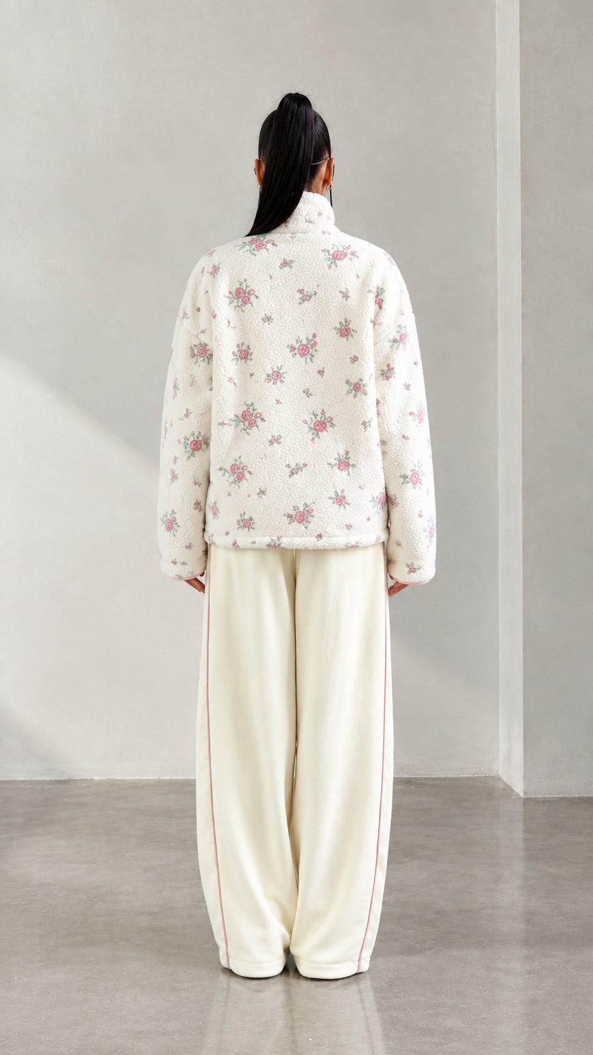 Back view of model wearing cream floral print plush fleece pullover
