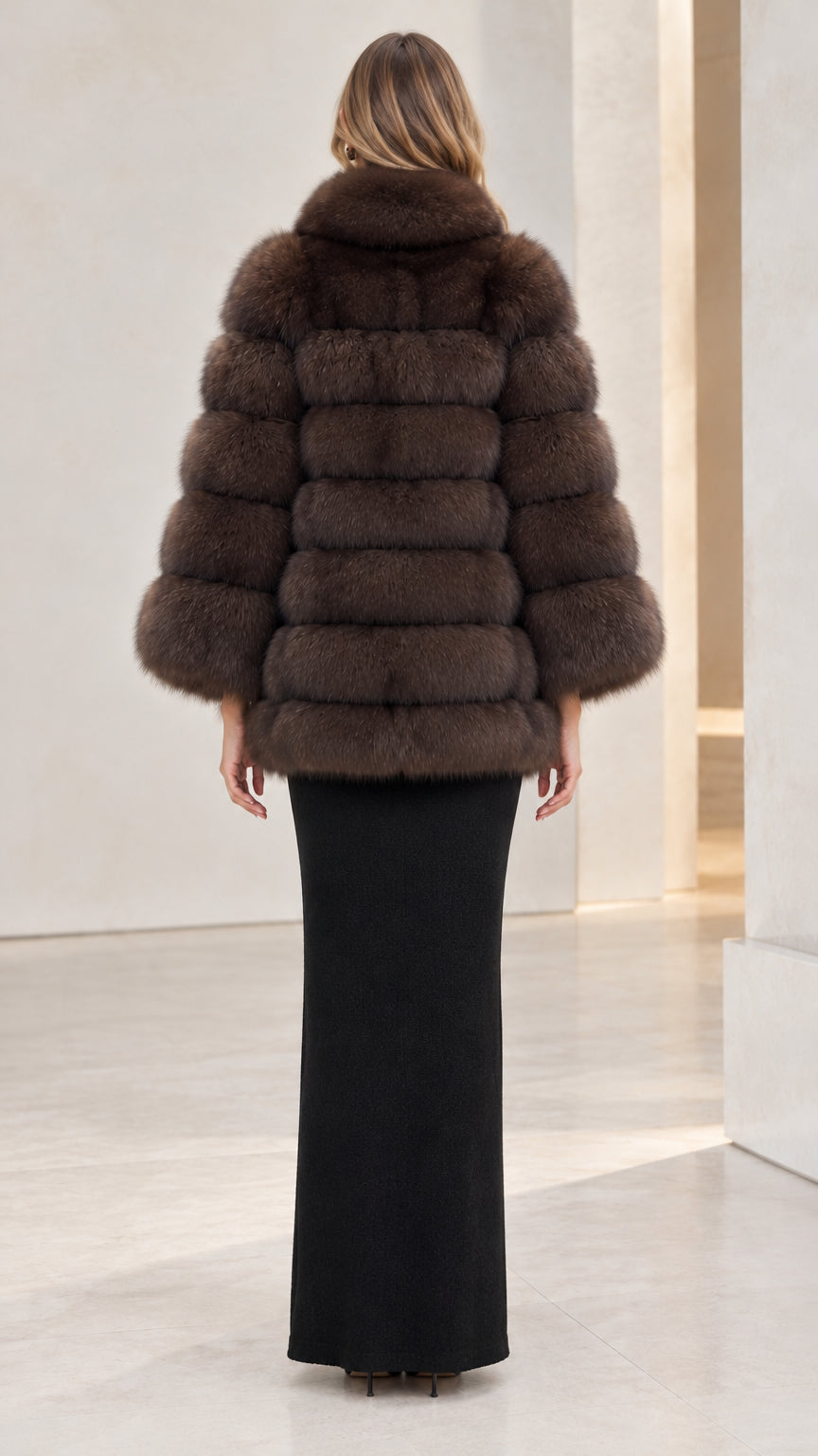 Back view of woman wearing chocolate brown tiered faux fur cape coat