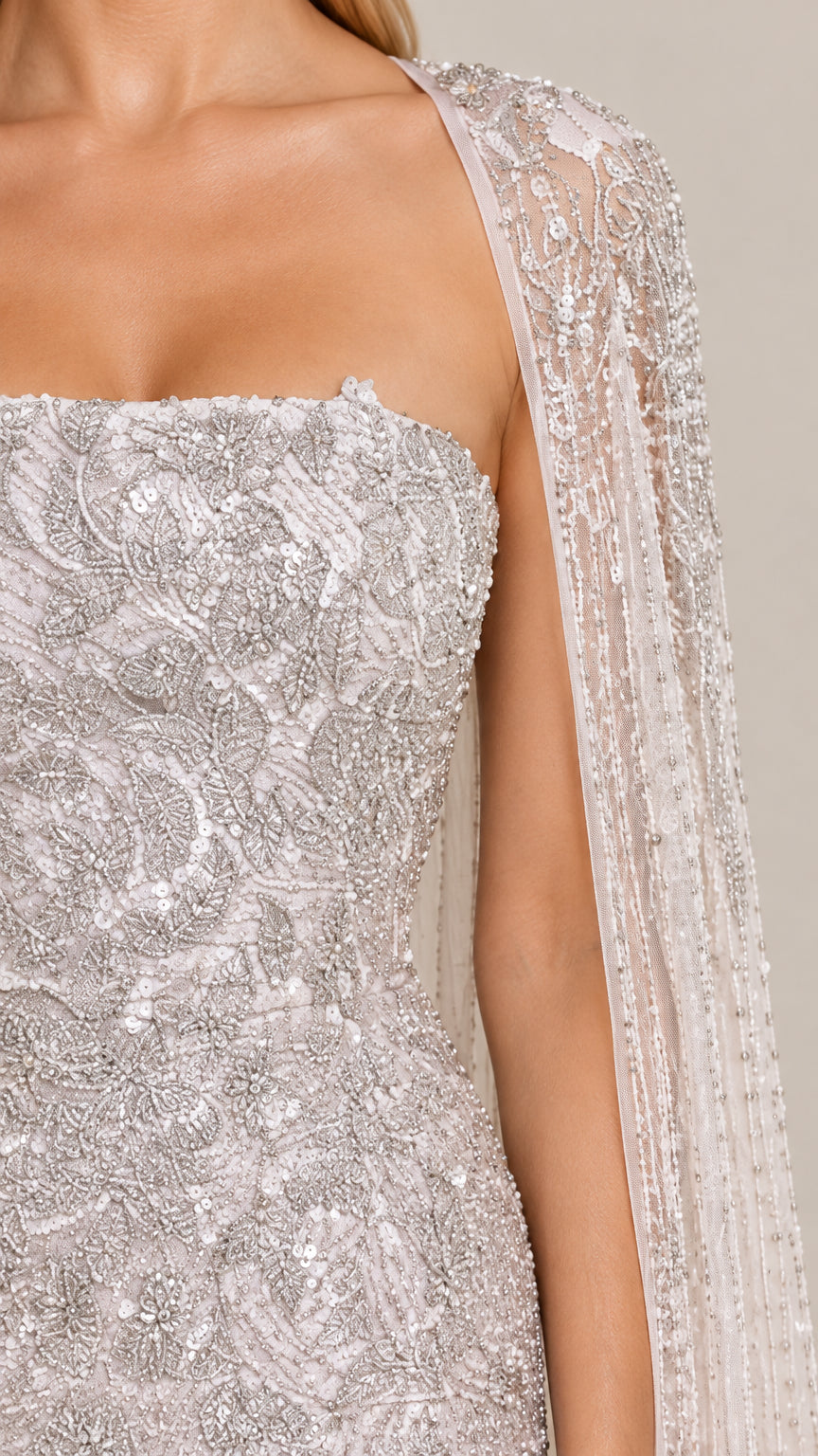 Close-up detail of silver sequin and bead floral embroidery on bodice and cape shoulder
