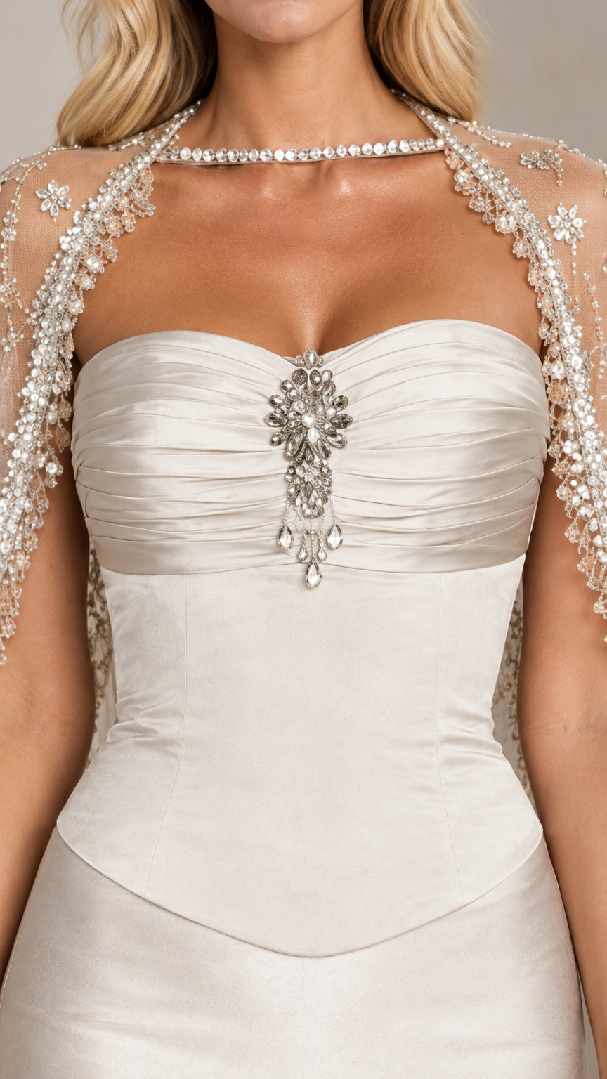 Close-up of ruched sweetheart bodice with crystal brooch and beaded capelet detail