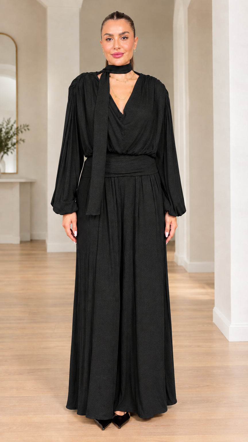 Model wearing black long-sleeve scarf neck wide-leg evening jumpsuit