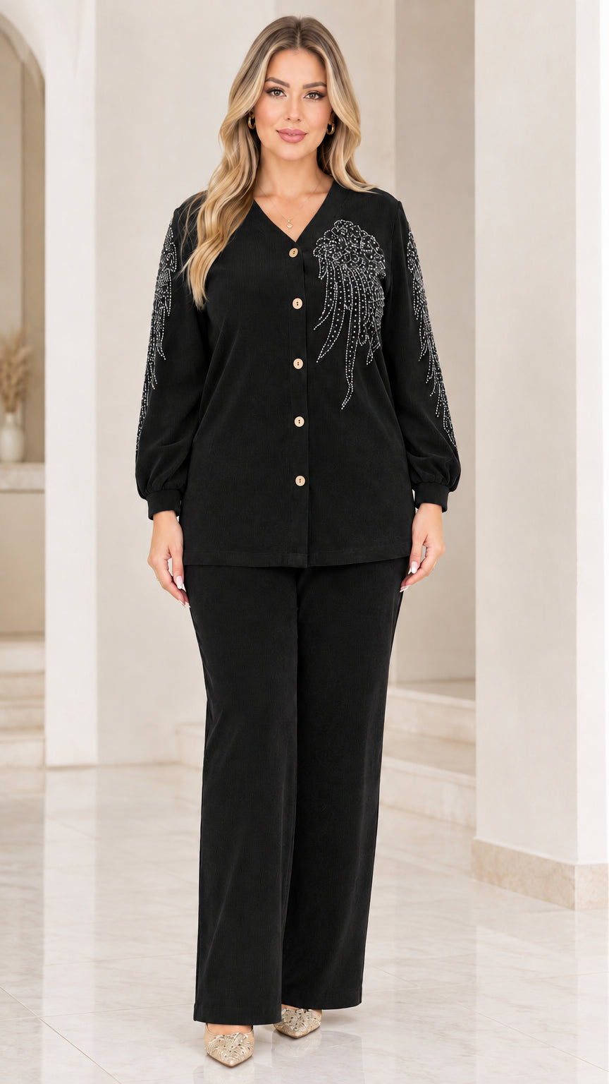 Front view of woman wearing black embellished ribbed two-piece pant set