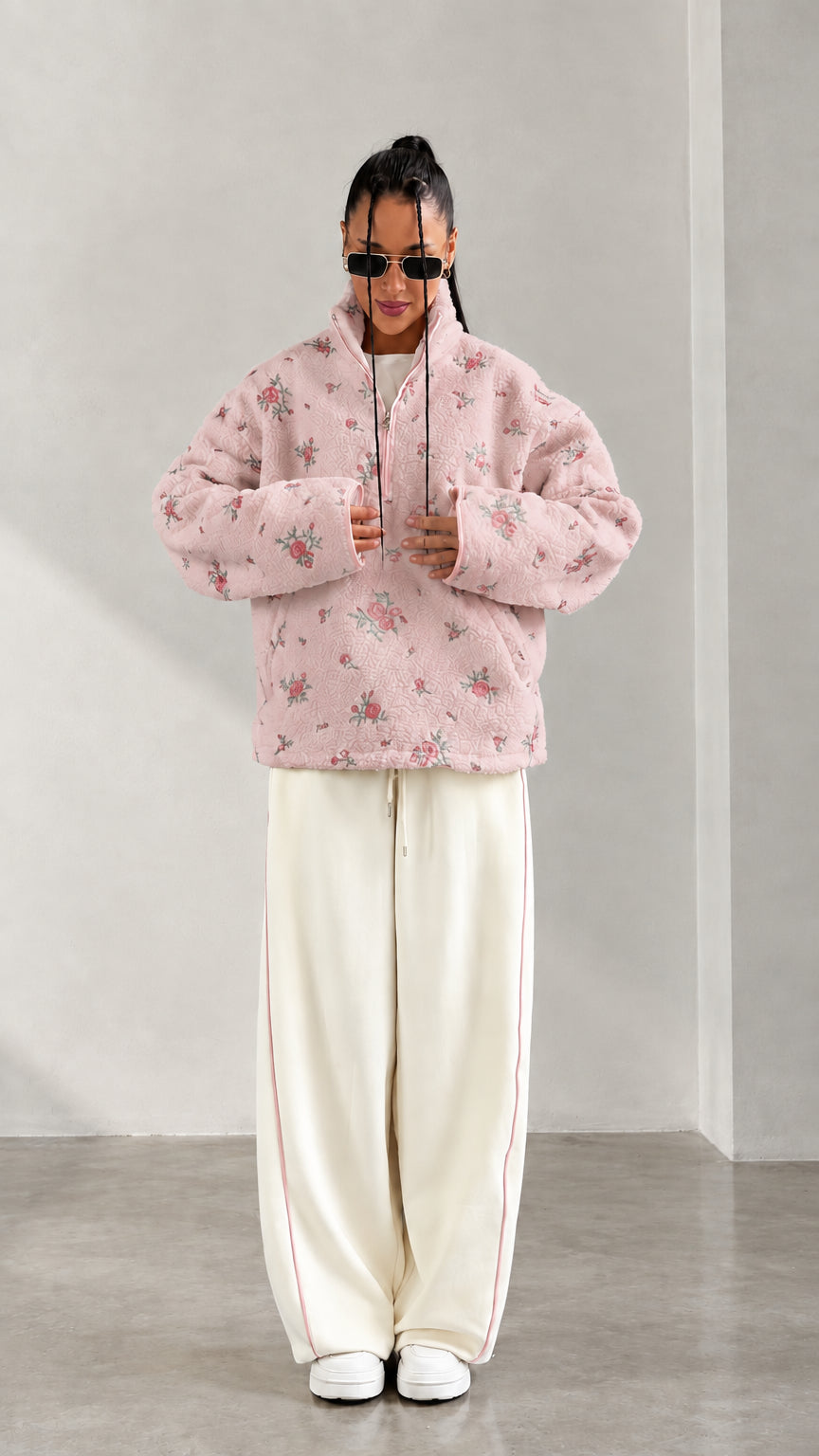 Front view of model wearing pink floral print half-zip fleece pullover