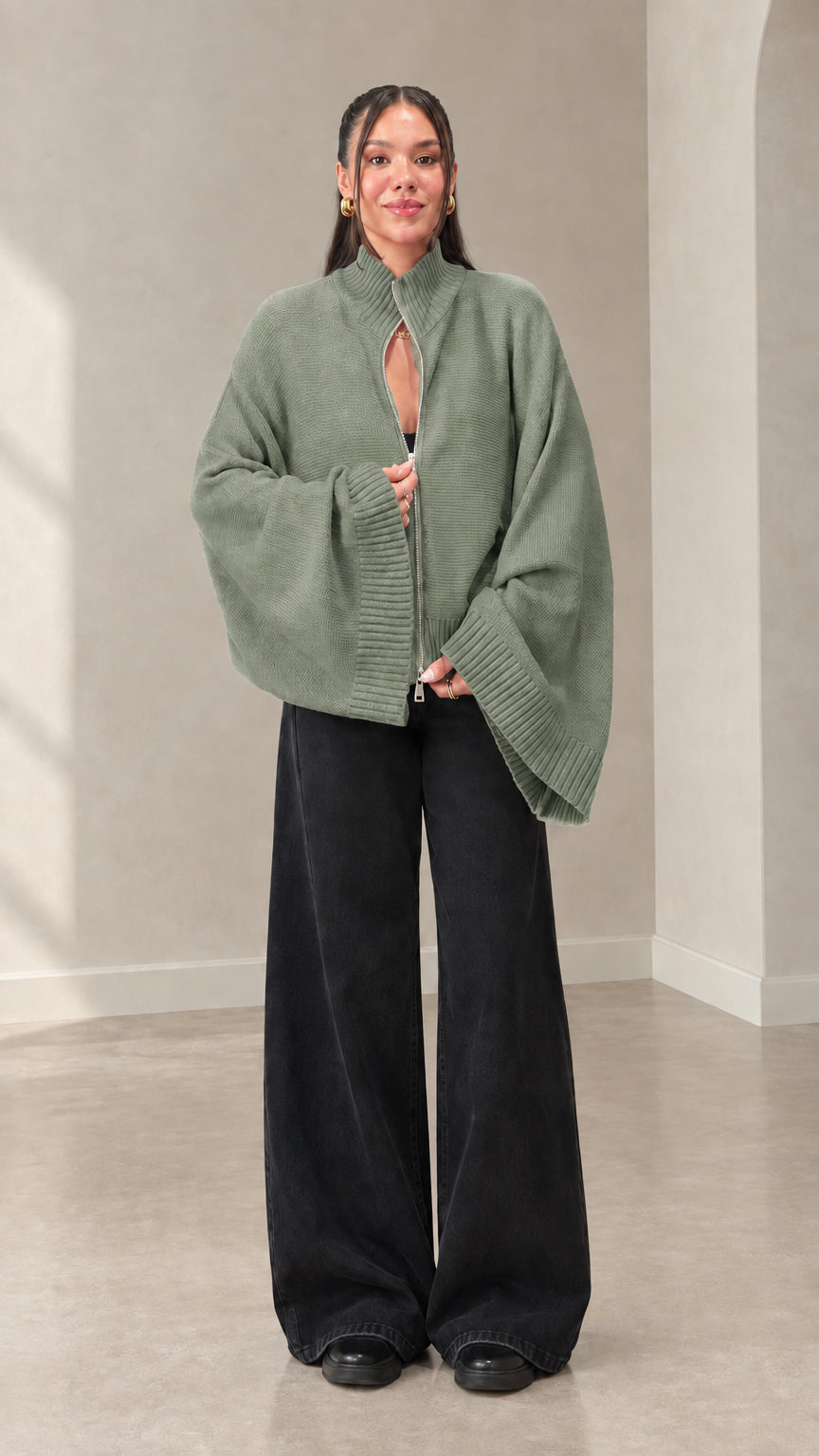 Woman wearing sage green batwing sleeve zip-up cardigan
