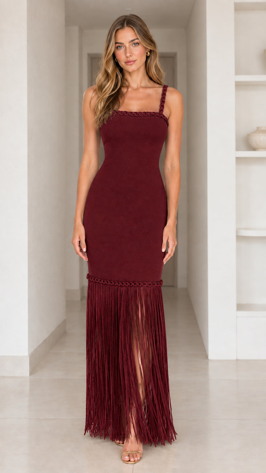Burgundy sleeveless formal maxi dress featuring braided trim and tassel fringe