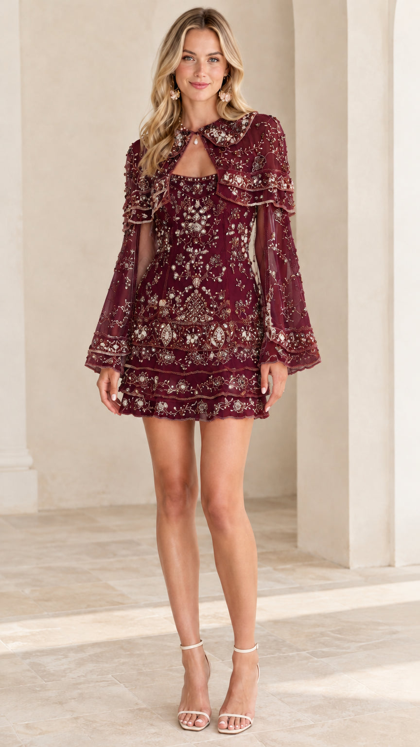 Front view of burgundy embellished capelet mini dress