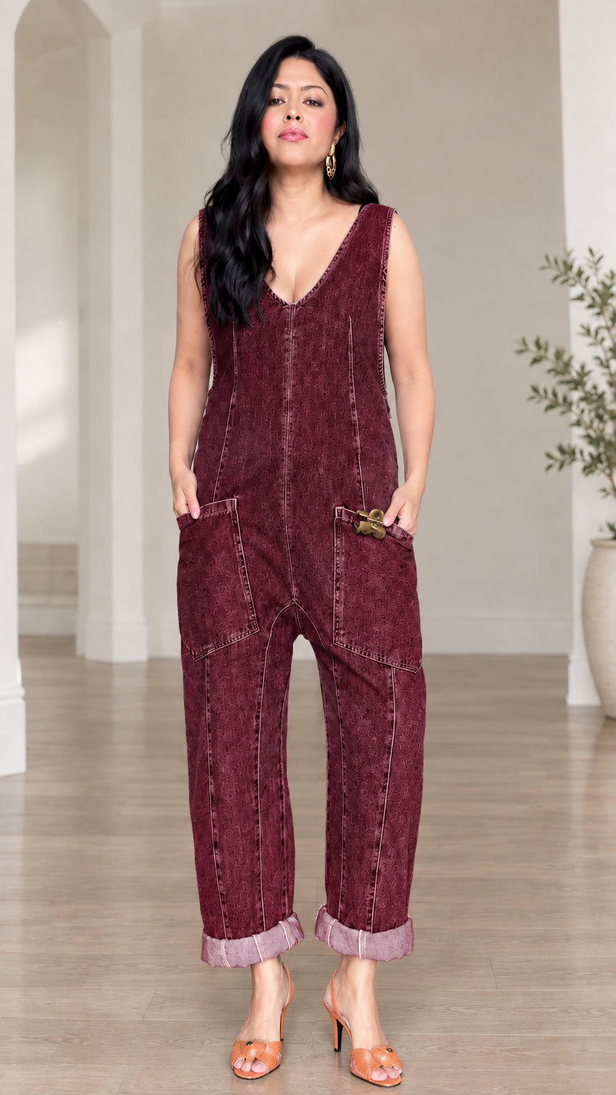 Model wearing burgundy wine red casual sleeveless jumpsuit