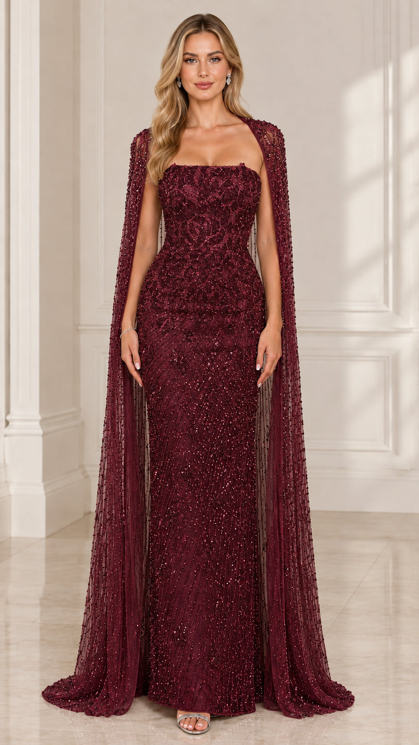 Front view of woman wearing burgundy wine red strapless embellished evening gown with cape overlay